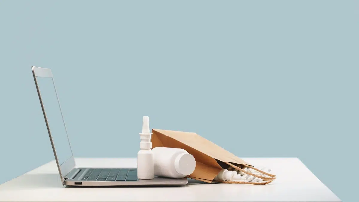 A bag full of medicines kept on top of a laptop