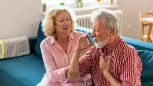 A woman showing the right way of how does an Aerocort inhaler work