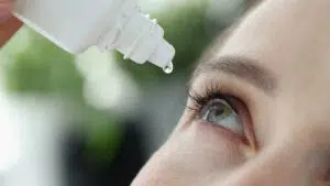 A woman with hazel eyes using Careprost eye drop